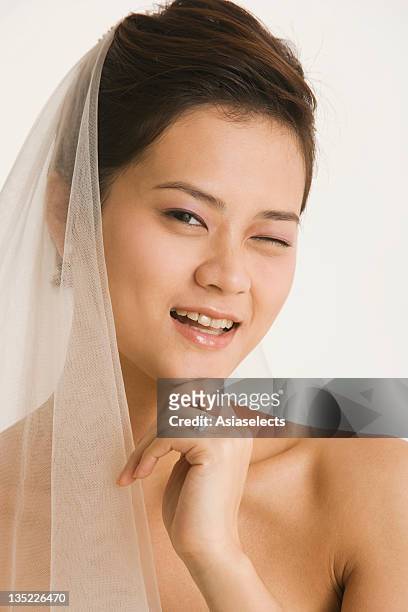 portrait of a bride winking and smiling - naughty bride stock pictures, royalty-free photos & images