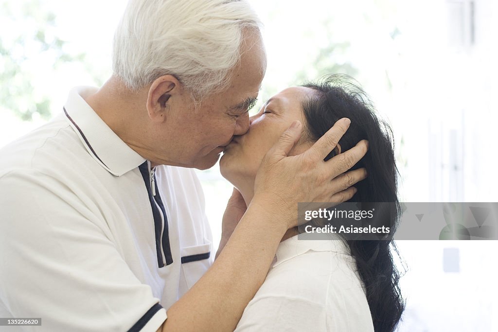 Close-up of a senior couple kissing each other