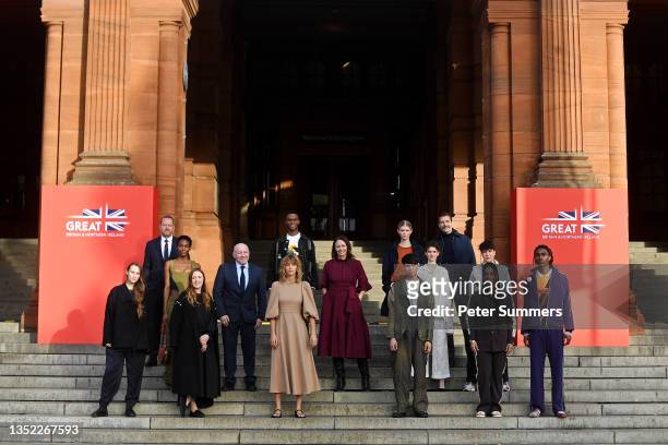 Chief Executive Officer of the British Fashion Council Caroline Rush poses with models and designers on the steps outside Kelvingrove Art Gallery and...