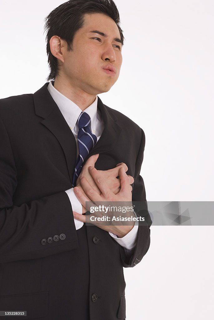 Close-up of a businessman suffering from chest pain