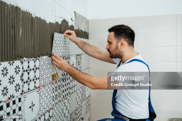 professional home builder at work - tile stock pictures, royalty-free photos & images