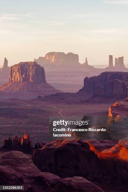wild west, monument valley from the hunt's mesa at sunset. utah - arizona border. portrait view, copy space - monument valley tribal park stock pictures, royalty-free photos & images