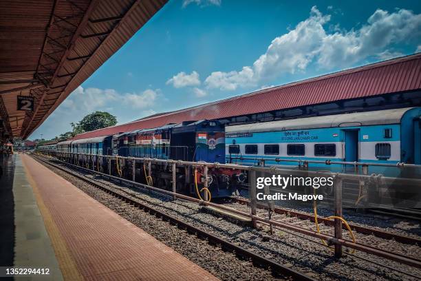 view from the platform with trains passing in india in a sunny day in delhi, india on march 17, 2021 - getting on stock pictures, royalty-free photos & images