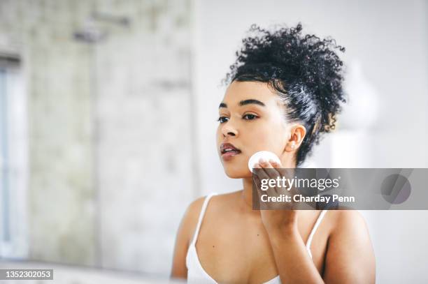 shot of a beautiful young woman going through her morning routine at home - applying makeup stock pictures, royalty-free photos & images