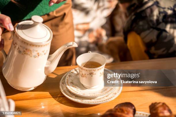 a teapot and a cup of tea on the table in the sunlight. - boiling water stock pictures, royalty-free photos & images