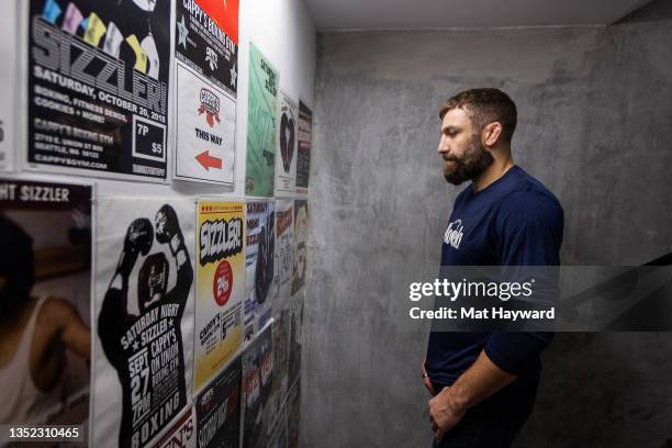 Mixed martial arts fighter and sports analyst Michael Chiesa looks at flyers as Modelo, UFC and Rebuilding Together renovate Cappy's Boxing Gym on...