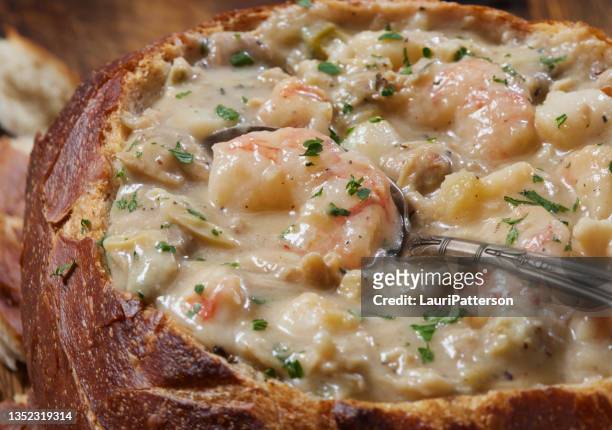 new england style seafood chowder in a sourdough bread bowl - new england clam chowder stock pictures, royalty-free photos & images