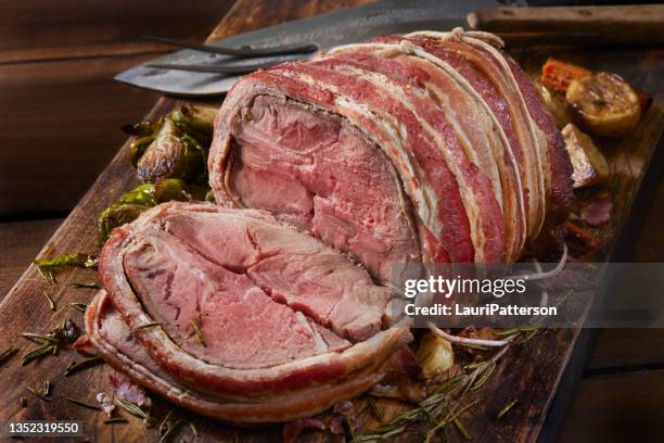 medium rare, bacon wrapped pork roast dinner - roast pork stock pictures, royalty-free photos & images