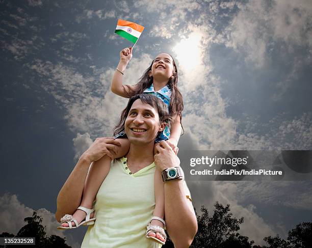 father and child with the indian flag - republic day photos et images de collection