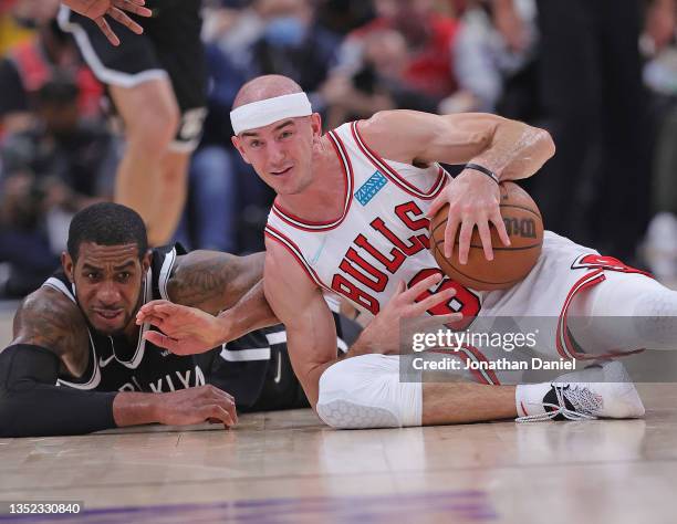Alex Caruso of the Chicago Bulls and LaMarcus Aldridge of the Brooklyn Nets battle for a loose ball at the United Center on November 08, 2021 in...