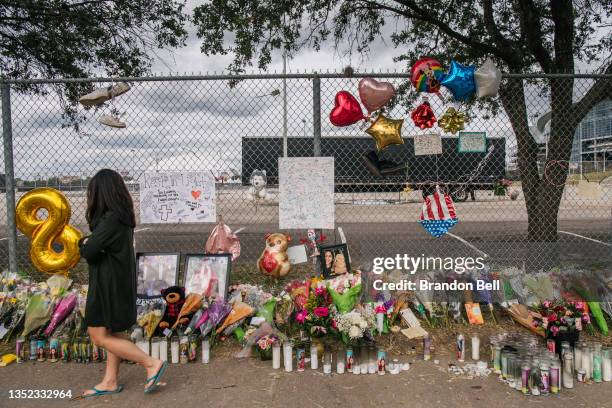 Woman walks past a memorial to those who died at the Astroworld festival outside of NRG Park on November 09, 2021 in Houston, Texas. Eight people...