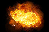 Realistic fiery explosion with sparks and smoke isolated on black background