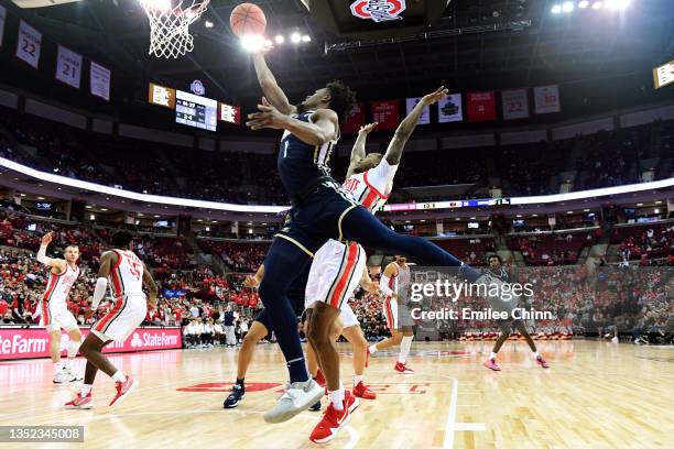 Walton of the Akron Zips drives to the basket against Cedric Russell of the Ohio State Buckeyes during the first half of the game at Value City Arena...