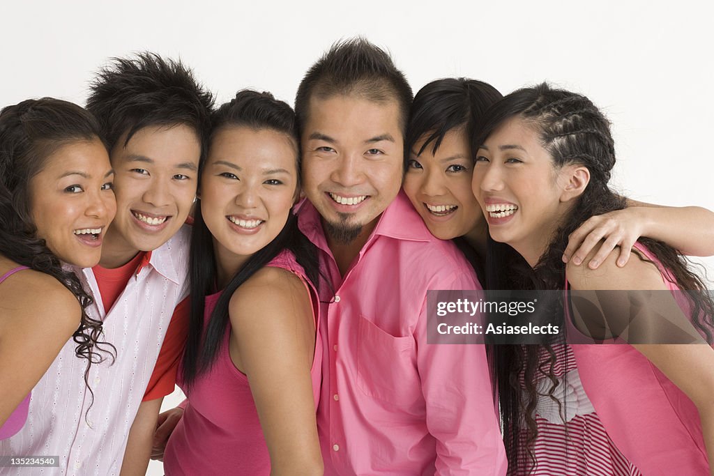 Two young men with four young women smiling