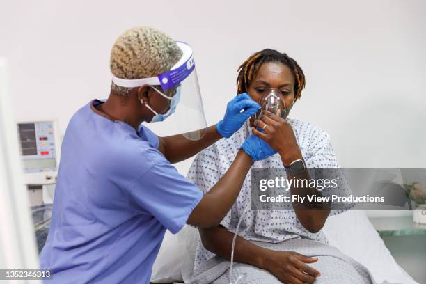 nurse assisting sick woman in hospital with medical ventilator for breathing - patient on ventilator stock pictures, royalty-free photos & images