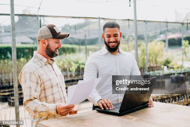 system analyst using technology in the plantation - laptop - young agronomist stock pictures, royalty-free photos & images