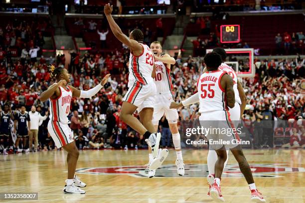 Zed Key of the Ohio State Buckeyes celebrates with teammates after his game-winning two point basket against the Akron Zips during the second half of...