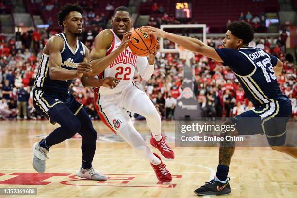 Malaki Branham of the Ohio State Buckeyes drives to the basket against K.J. Walton and Xavier Castaneda of the Akron Zips during the second half of...