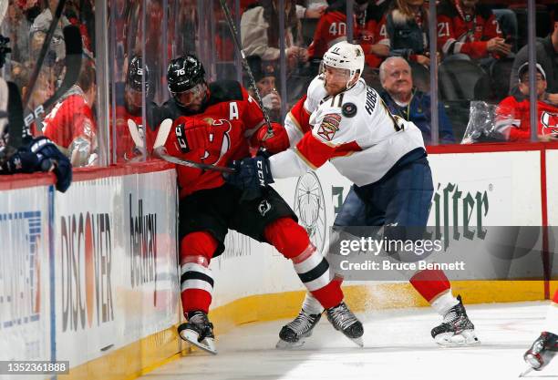 Jonathan Huberdeau of the Florida Panthers checks P.K. Subban of the New Jersey Devils into the boards during the second period at the Prudential...