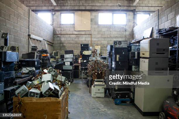 recycling plant storage full of obsolete computer electronics equipment - obsolete stock pictures, royalty-free photos & images