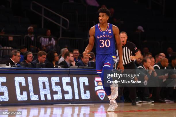 Ochai Agbaji of the Kansas Jayhawks celebrates after hitting a three pointer against the Michigan State Spartans during the State Farm Champions...