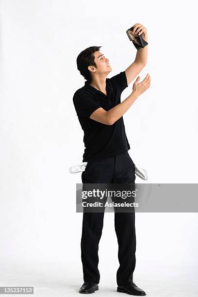 young man holding an empty wallet - empty pockets stock pictures, royalty-free photos & images