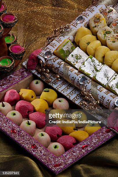sweet dishes and unlit diyas - mithai stock pictures, royalty-free photos & images