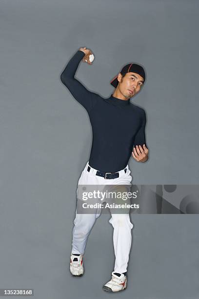 portrait of a young man throwing a baseball - baseball pitcher isolated stock pictures, royalty-free photos & images