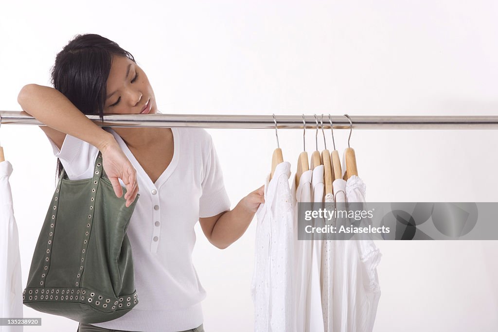 Young woman leaning on a clothes rail
