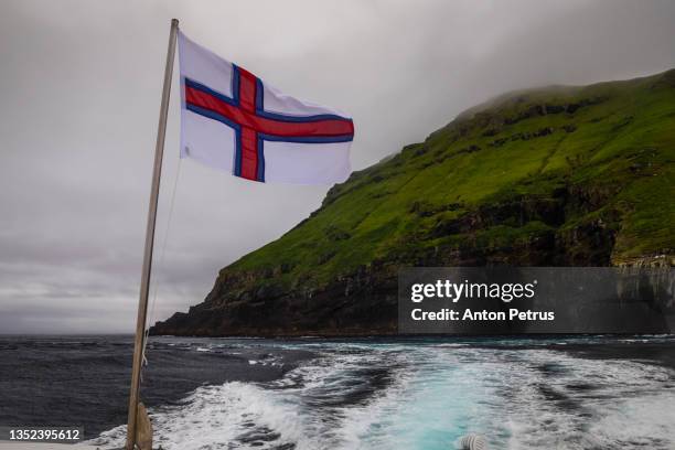 view of the fjord from the ferry in dramatic weather. faroe islands - faroe islands photos et images de collection