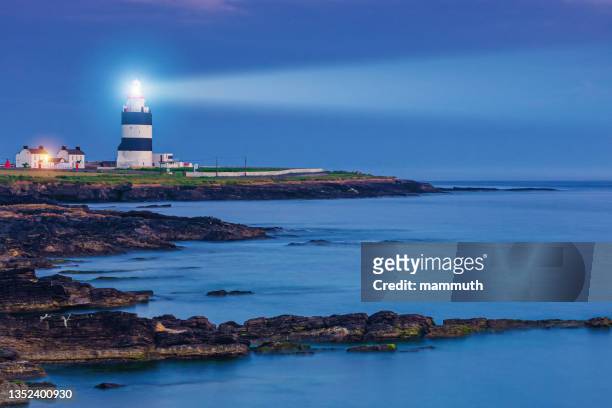 lighthouse in the night - beacon stock pictures, royalty-free photos & images