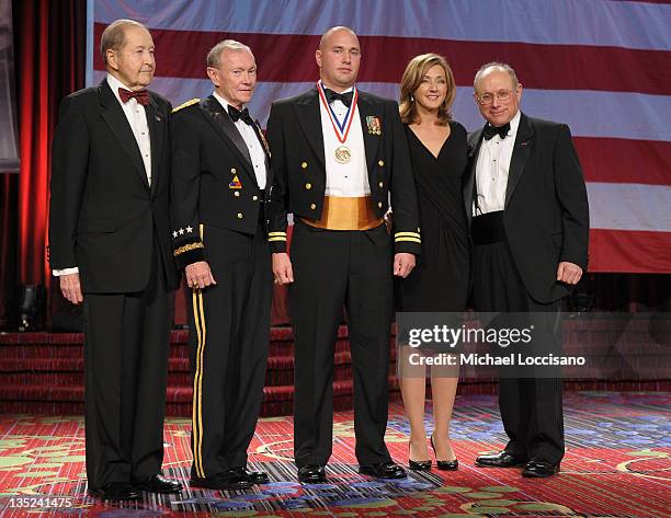 Oliver Mendell, Martin E. Dempsey, Coast Guardsman of the year Lieutenant Jason Moritz, Chris Jansing and Myron Berman pose onstage at the 50th USO...