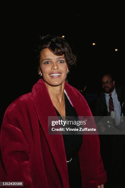 American actress and singer Shari Belafonte, wearing a deep red coat over a black outfit, attends the Genesis Awards, circa 1995. Awarded annually by...