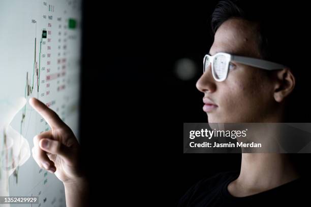 millennial generation boy on smart screen - market intelligence imagens e fotografias de stock