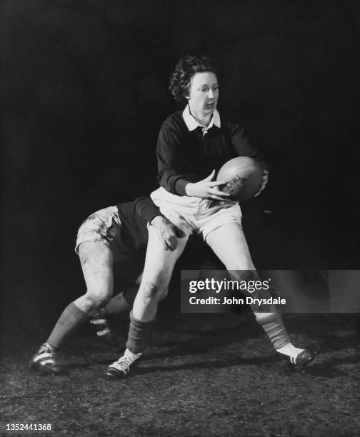 Sheila Young from the Edinburgh University Amazons Women's Rugby Team prepares to pass the ball during a training session circa September 1962 at The...