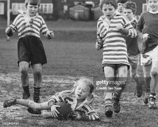 Seven year old Yvonne Davis of Clapgate Primary School dives to the ground with the ball during a school rugby league match on 5th April 1972 at...