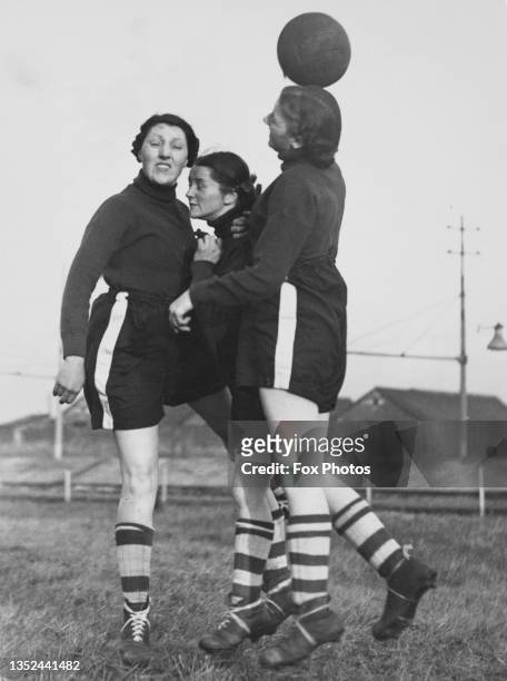 Footballers for the Bolton Women's Football and Athletic Club practice heading the ball during a training session on 7th December 1939 at Raikes Park...