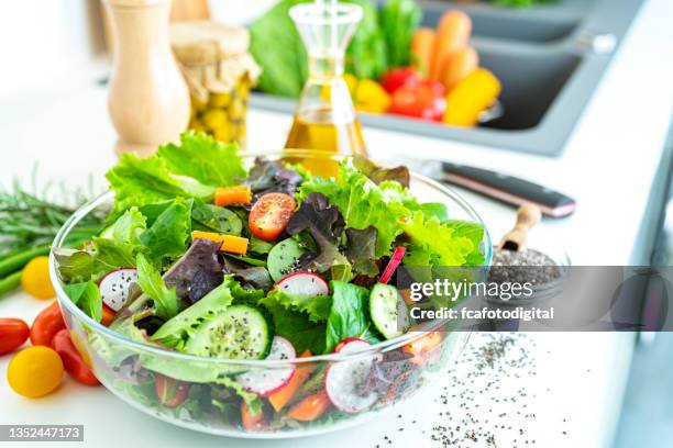 fresh salad bowl on kitchen counter - green salad stock pictures, royalty-free photos & images