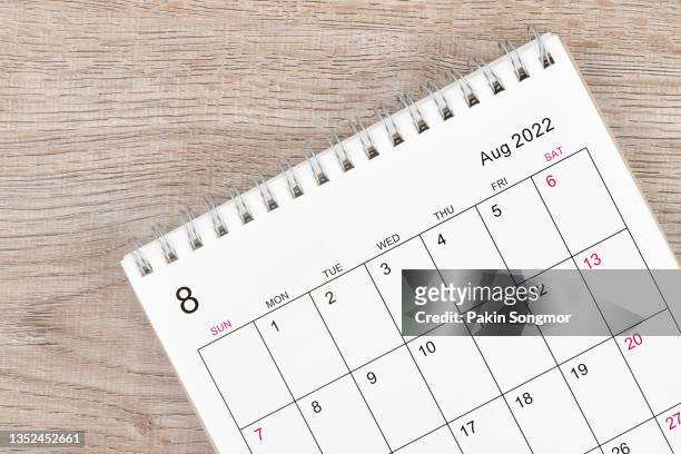 calendar desk 2022 on august month, top view calendar desk on wooden table background. - august stock pictures, royalty-free photos & images
