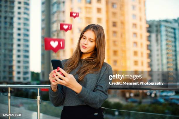 young urban woman gets likes on social media - like button stock-fotos und bilder