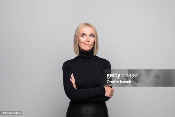 portrait of displeased mature businesswoman - polo neck stock pictures, royalty-free photos & images