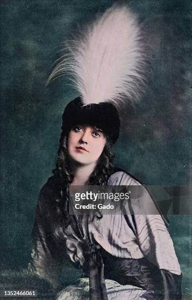 Three quarter length portrait of Mabel Normand wearing a feathered hat, 1914. Note: Image has been digitally colorized using a modern process. Colors...