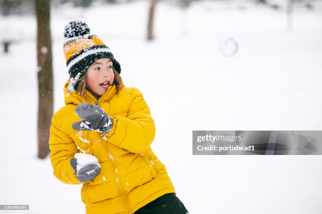 Little child playing in the snow