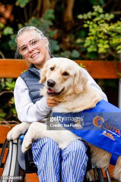 Frieda Krieger and her dog Ayden during the Purina appeal campaign for VITA Assistenzhunde on September 28, 2021 in Huemmerich near Bonn, Germany.