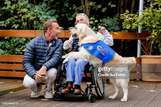 Host Jochen Bendel and Frieda Krieger with her dog Ayden during the Purina appeal campaign for VITA Assistenzhunde on September 28, 2021 in...