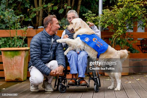 Host Jochen Bendel and Frieda Krieger with her dog Ayden during the Purina appeal campaign for VITA Assistenzhunde on September 28, 2021 in...