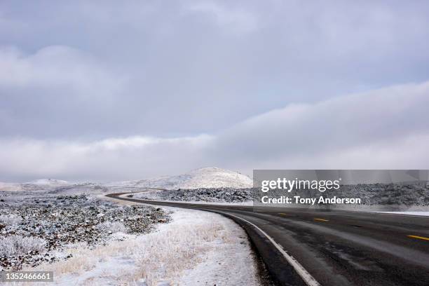 road winding through winter landscape - ketchum idaho stock pictures, royalty-free photos & images