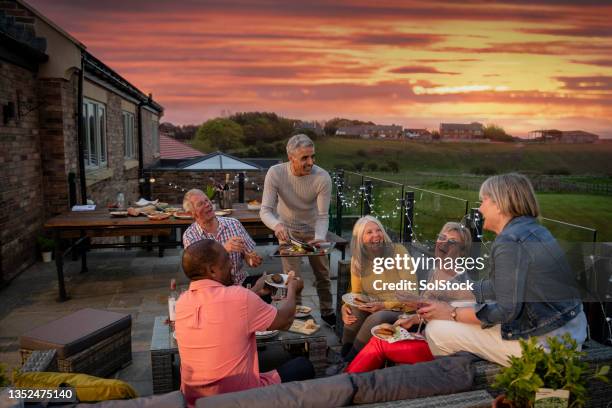enjoying the summer sunset - al fresco dining stock pictures, royalty-free photos & images