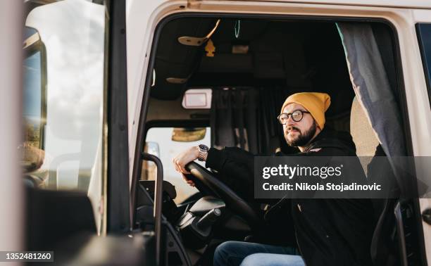 portrait of young caucasian bearded truck driver - trucker stock pictures, royalty-free photos & images