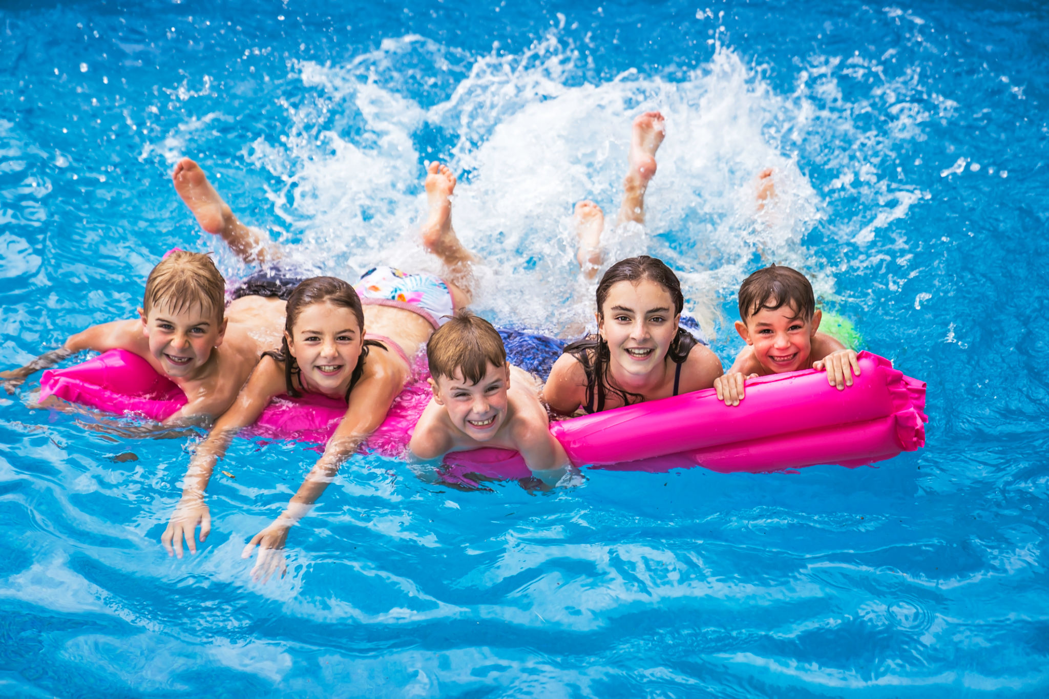 group of children having fun in Pool on the summer time group of children having fun in Pool on the summer time